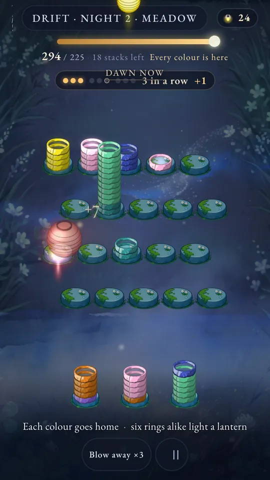 Drift, the second night in the Meadow: tall stacks of yellow, pink, green and blue rings, and a red lantern just lit