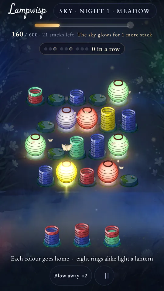 Sky, the first night in the Meadow: glowing lanterns among stacks of coloured rings on mossy stones